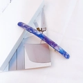 Macro detail of acetate hair clip featuring blue and purple marble stone textures - Lake Blue