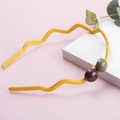 Detail showing wavy yellow headband with contrast beads and non-slip inner teeth - Yellow