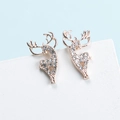 Macro shot of elegant golden reindeer stud earrings with crystal pave diamonds - Rose Gold