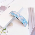 Détail de la pince à cheveux élégante en acétate bleu ciel et blanc avec fermoir en métal - Texture Bleu Ciel