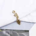 Detailed close-up of a bronze owl pendant on a spiral hair ring for dreadlocks - Dotted Owl Style (E7528-24#)