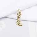 Macro shot of gold Om symbol pendant on spiral hair ring accessory with vintage texture - Religious Om Symbol Style (E7525-9#)