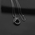 Detail of silver Ouroboros dragon pendant on a fine square chain with metallic luster - Snake + Stainless Steel Chain