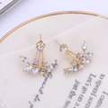Detailed close-up of golden leaf-shaped earrings with sparkling zircon crystals on white lace - Gold (B3203)