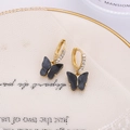 Golden hoop earrings with sparkling rhinestones and elegant black acrylic butterfly charms - Black