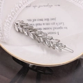 Detail of leaf-shaped hair clip with silver alloy and marquise crystals in a ceramic dish - Bar Shape Style / Silver