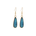 Detail view of gold drop earrings featuring sparkling blue resin crystal texture - Light Blue