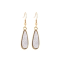 Detail of gold teardrop earrings with shimmering silver crystals in a minimalist frame - White