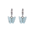 Close-up of light blue acetate butterfly drop earrings with polished silver hoops - Blue