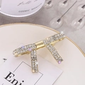 Elegante fermaglio per capelli a fiocco dorato con strass su un piatto di ceramica - Clip Laterale a Fiocco (C2421) / Oro