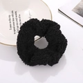 Plush black faux lamb wool scrunchie accessory displayed on a stylish white plate - Black (N2404)