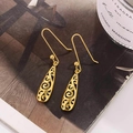 Vintage Celtic style hollow gold drop earrings with intricate floral filigree patterns - Gold