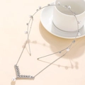 Elegant silver pearl headband with rhinestone tassels and drop pearl on a white cup - Silver (C8134)