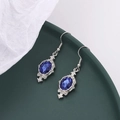 Detailed macro view of vintage royal blue teardrop earrings in antique silver frames - Sapphire Blue Silver