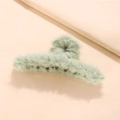 Detail shot of light green faux fur hair claw clip with soft plush texture on pink background - Mint Green