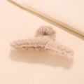 Close-up of soft plush hair claw clip in beige faux fur with visible gripping teeth - Apricot