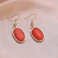 Fashionable oval red marble drop earrings with gold hooks on satin fabric - Orange Red