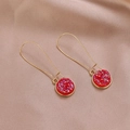 Macro shot of red resin earrings with shimmering glitter on a champagne silk background - AB Red (B1317)