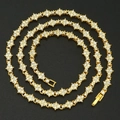 Golden tennis necklace with floral cross links and white cubic zirconia stones - 18cm / Gold