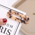 Macro detail of rectangle acetate hair clip with amber tortoise shell pattern texture - Light Leopard