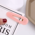 Macro shot of pink translucent acetate hair clip with a golden metal duckbill clamp - Pink Gold Powder