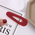 Detail of red glitter oval hair clip with hollow center and golden metal duckbill base - Red Gold Powder