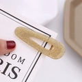 Detailed macro view of a gold glitter teardrop hair clip with a polished metal base - Light Coffee Glitter