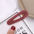 Close-up of matte dark red waterdrop hair clip with golden metal inner spring mechanism - Matte Red