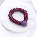 Spiral elastic hair tie in deep purple with a matte round bead on marble background - Deep Purple (D6117)