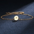 Elegant gold chain bracelet with round metal pendant featuring the letter P engraving - Letter P