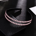 Detail view of double-layered black headband with pink rhinestone flower decorations - Pink Headband