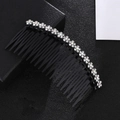 Close-up of black plastic hair comb with sparkling white rhinestone flower decorations - White Hair Comb