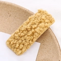 Detail of a rectangular hair clip featuring soft ginger faux lamb wool texture for kids - Yellow
