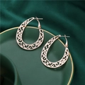 Vintage hollow rose gold alloy hoop earrings with ethnic swirl pattern on a tray - Rose Gold