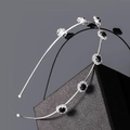 Detail showing double-layer silver headband with black gemstone and white rhinestone floral motifs - Silver Black Rhinestone Style (I5209)
