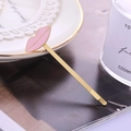 Chic gold-tone hairpin with pink enamel lips design on a white lace plate setting - Pink