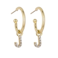 Close-up of golden letter J pendant earrings with sparkling pavé crystal accents - Gold J