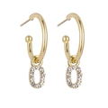 Detail of gold hoop earrings with crystal-encrusted letter O pendant and polished finish - Gold O
