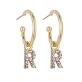 Detail view of gold hoop earrings with sparkling crystal letter R pendant charms - B1227 Gold R
