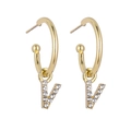 Detail of gold C-shaped hoop earrings featuring rhinestone-studded letter V pendants - B1231 Gold V
