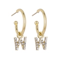Detailed view of gold C-shaped hoop earrings featuring crystal-encrusted letter W charms - B1232 Gold W