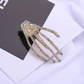 Gothic gold skull hand hair clip with white and blue rhinestones on a stylish card - Lake Blue (C3207)