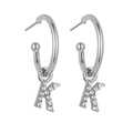 Close-up of silver letter K hoop earrings with sparkling crystal pavé stones - Silver K