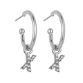Macro view of silver hoop earrings featuring sparkling crystal-paved letter X pendants - B1233 Silver X