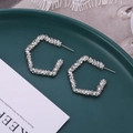 Détail macro de boucles d'oreilles géométriques argentées à texture sur céramique verte - Style Losange (A7421) / Argent