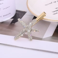 Detailed macro view of starfish hair clip with sparkling crystals and golden metallic base - White Diamond Gold Style (C4313)