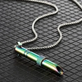 Close-up of rainbow stainless steel whistle pendant necklace with a textured decorative ring - Spinning Bead Rainbow Whistle