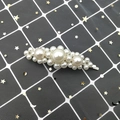 Detail of floral-shaped pearl hair clip with silver metal base on a mesh background - Straight Large Pearl Style (G4108) / Silver