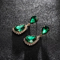 Detailed macro of vintage gold drop earrings with emerald green teardrop crystals - Gold Green
