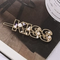 Goldene KISS Buchstaben Haarspange mit weißen Perlen und funkelnden Strasssteinen - KISS Stil / Gold